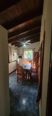 a kitchen and dining room with a table and chairs at Cabaña Hakuna matata in Santa Rosa de Calamuchita