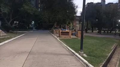 two people sitting on a bench in a park at Apartment in the City of Cordoba for 4 people and parking in Cordoba