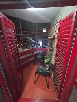 a room with red doors and a table and chairs at Apartment in the City of Cordoba for 4 people and parking in Cordoba