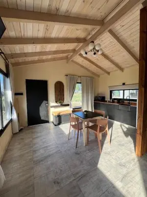 a dining room with a table and chairs in a room at algo con sierras in Villa Yacanto
