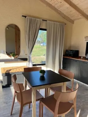 a room with a table and chairs and a bed at algo con sierras in Villa Yacanto