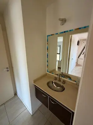 a bathroom with a sink and a mirror at Departamento en el corazón de Villa Carlos Paz in Villa Carlos Paz