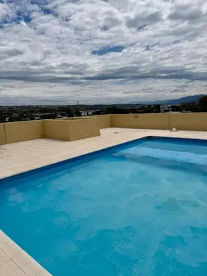 a large swimming pool on the roof of a building at Departamento en el corazón de Villa Carlos Paz in Villa Carlos Paz