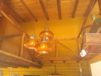 a group of lights hanging from a ceiling at Cabañas aguaribay in Villa Parque Siquiman