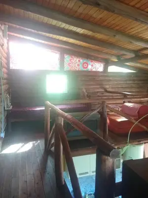 a room with a bunk bed in a cabin at Cabañas aguaribay in Villa Parque Siquiman