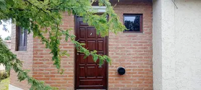 a brick building with a large wooden door at Un rincón en el centro in Merlo