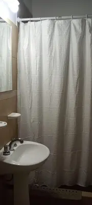 a bathroom with a sink and a shower curtain at Un rincón en el centro in Merlo