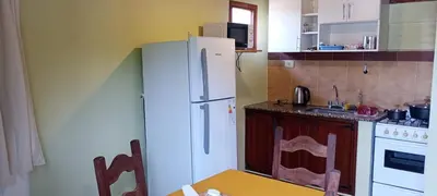 a kitchen with a white refrigerator and a stove at Un rincón en el centro in Merlo