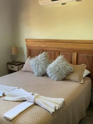 a bed with two towels and a robe on it at Postal de América in Villa Ciudad de America