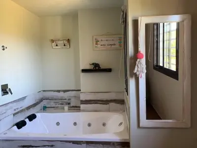 a bathroom with a bath tub in a room at Postal de América in Villa Ciudad de America