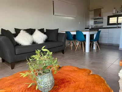 a living room with a couch and a table at Postal de América in Villa Ciudad de America