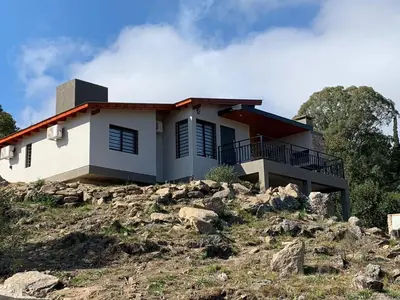 a house on top of a hill at Postal de América in Villa Ciudad de America