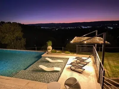 a swimming pool with lounge chairs next to a swimming pool at Postal de América in Villa Ciudad de America