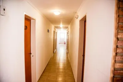 a corridor of an empty hallway in a building at Clima Sol in Merlo