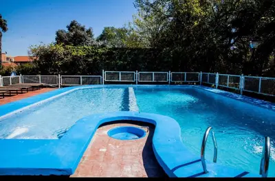 a large swimming pool with blue water at Clima Sol in Merlo