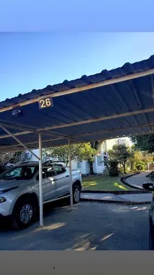 a car parked in a parking lot with a blue cover at Departamento en calle 9 de Julio in Cordoba
