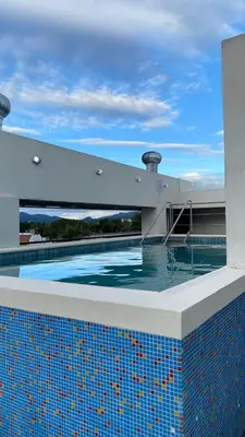a swimming pool on the roof of a building at Departamento Villa 5 in Villa Carlos Paz