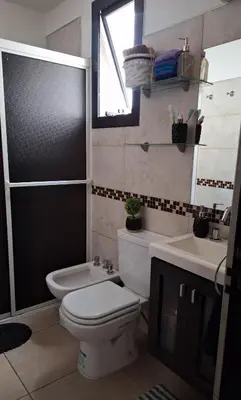 a bathroom with a toilet and a sink at Departamento Villa 5 in Villa Carlos Paz