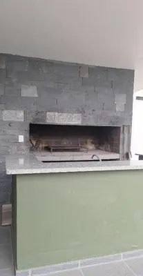 a brick wall with a fireplace on top of it at Departamento Villa 5 in Villa Carlos Paz