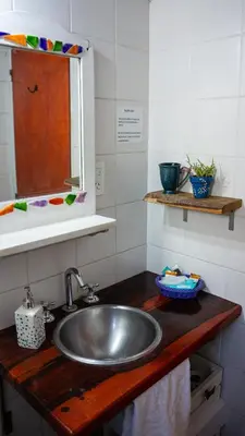 a kitchen counter with a sink and a mirror at Casita Meraki Duplex para 3 personas in Villa Carlos Paz