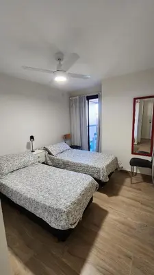 a bedroom with two beds and a ceiling fan at Obispo Salguero 648 - Pleno Nueva Cordoba BY Apartcba in Cordoba