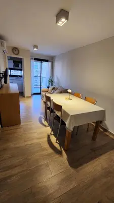 a room with a table and chairs and a kitchen at Obispo Salguero 648 - Pleno Nueva Cordoba BY Apartcba in Cordoba