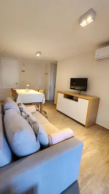 a living room with a couch and a tv at Obispo Salguero 648 - Pleno Nueva Cordoba BY Apartcba in Cordoba