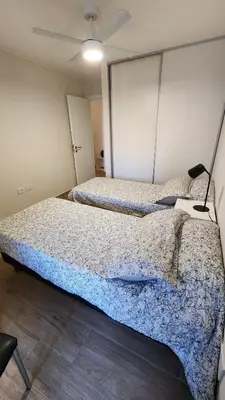 a bedroom with two beds and a ceiling fan at Obispo Salguero 648 - Pleno Nueva Cordoba BY Apartcba in Cordoba