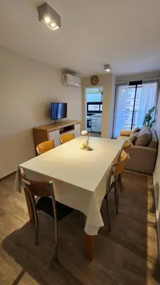 a living room with a large white table and chairs at Obispo Salguero 648 - Pleno Nueva Cordoba BY Apartcba in Cordoba