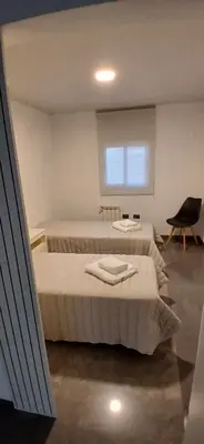 a bedroom with two beds and a chair at alecayluna in Berrotarán