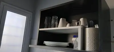 a shelf with plates and dishes on it with a mirror at alecayluna in Berrotarán