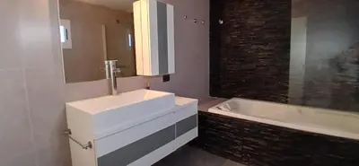 a bathroom with a white sink and a bath tub at alecayluna in Berrotarán
