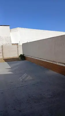a parking lot in front of a building at alecayluna in Berrotarán