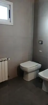 a bathroom with a white toilet and a window at alecayluna in Berrotarán