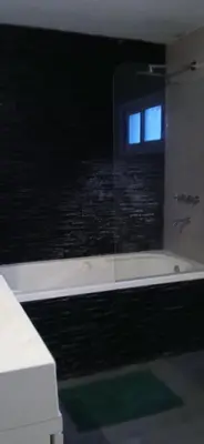 a bathroom with a window and a bath tub at alecayluna in Berrotarán