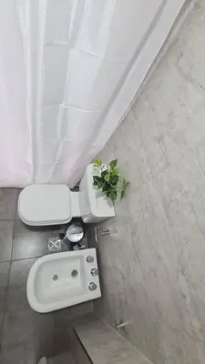 a bathroom with a white toilet and a sink at ALLEGRA Lake Towers - Nuevo y moderno! Exc ubicación -Lo vas a amar in Villa Carlos Paz