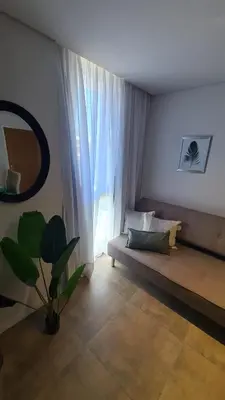 a living room with a couch and a large window at ALLEGRA Lake Towers - Nuevo y moderno! Exc ubicación -Lo vas a amar in Villa Carlos Paz