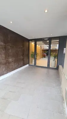 an empty lobby with glass doors in a building at ALLEGRA Lake Towers - Nuevo y moderno! Exc ubicación -Lo vas a amar in Villa Carlos Paz