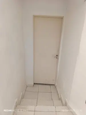 an empty room with a white door and a tile floor at Soles in Cordoba