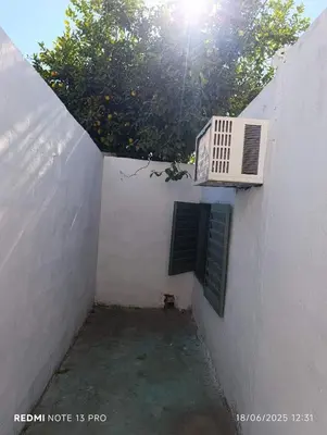 a white building with a window and a air conditioner at Soles in Cordoba