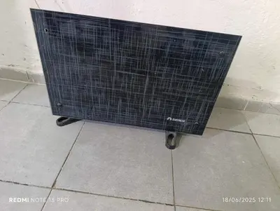 a black cage sitting on the floor next to a wall at Soles in Cordoba