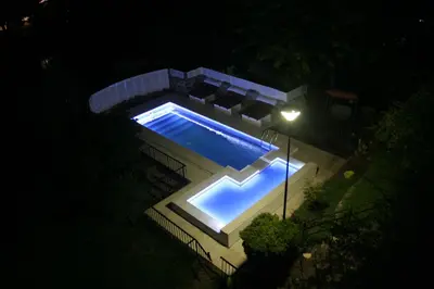 an overhead view of a swimming pool at night at Casa Alta Hotel Boutique & Spa - Solo Adultos in Villa Carlos Paz