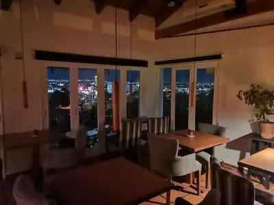 a restaurant with a view of the city at night at Casa Alta Hotel Boutique & Spa - Solo Adultos in Villa Carlos Paz