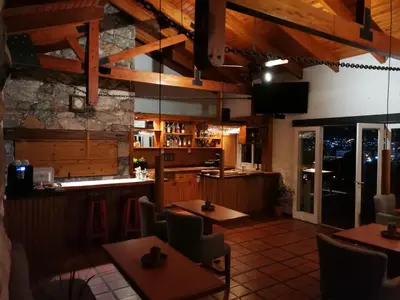 a restaurant with tables and chairs and a bar at Casa Alta Hotel Boutique & Spa - Solo Adultos in Villa Carlos Paz