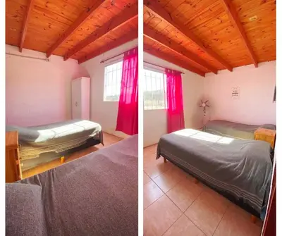 two beds in a room with red curtains at Aires de Paz in San Roque