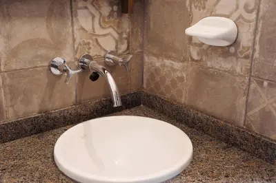 a bathroom with a toilet and a sink at Lila Casas de Montaña in La Cumbrecita