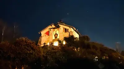 a house sitting on top of a hill at night at Lila Casas de Montaña in La Cumbrecita