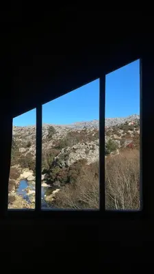 a window with a view of a desert view at Lila Casas de Montaña in La Cumbrecita