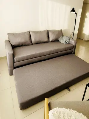 a brown couch in a living room with a table at Departamento en Carlos Paz con vistas y céntrico in Villa Carlos Paz