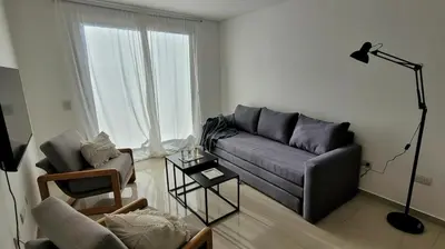 a living room with a couch and a chair at Departamento en Carlos Paz con vistas y céntrico in Villa Carlos Paz